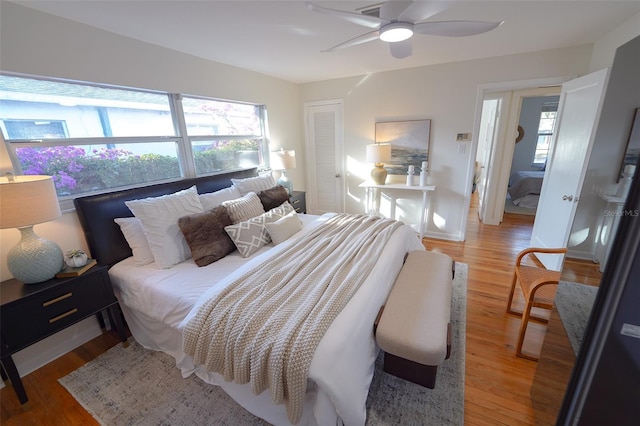 bedroom featuring wood-type flooring, a closet, and ceiling fan