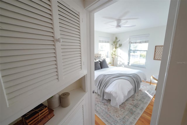 bedroom with hardwood / wood-style floors and ceiling fan