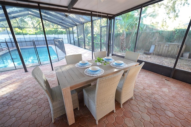 sunroom featuring vaulted ceiling