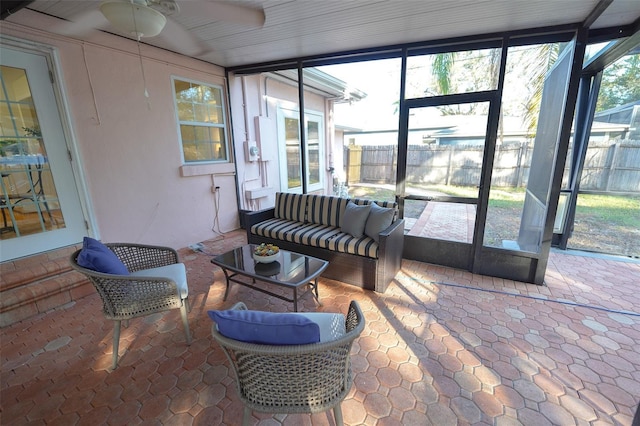 sunroom featuring plenty of natural light and ceiling fan