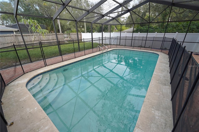 view of swimming pool featuring a lanai