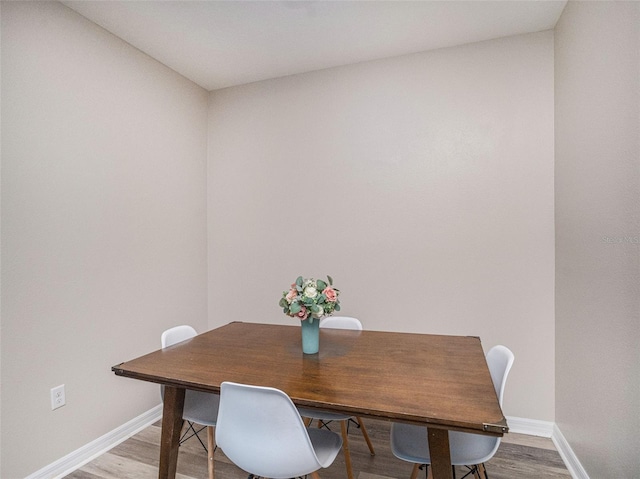 dining space featuring wood-type flooring