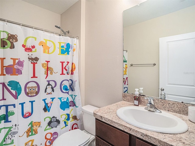 bathroom with vanity, a shower with shower curtain, a textured ceiling, and toilet