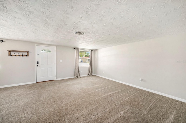 interior space featuring a textured ceiling and carpet floors