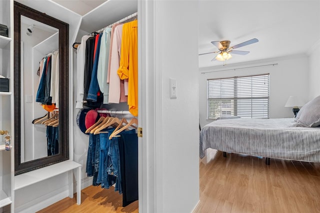 bedroom featuring ornamental molding, light hardwood / wood-style flooring, and ceiling fan