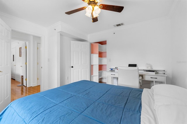 bedroom with ceiling fan, ornamental molding, and light hardwood / wood-style floors