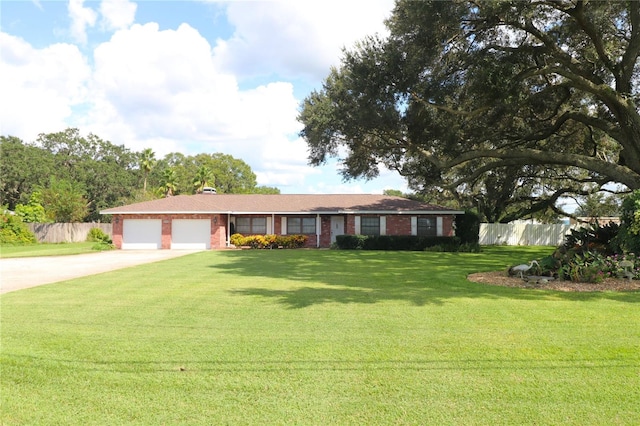 ranch-style home with a garage and a front lawn