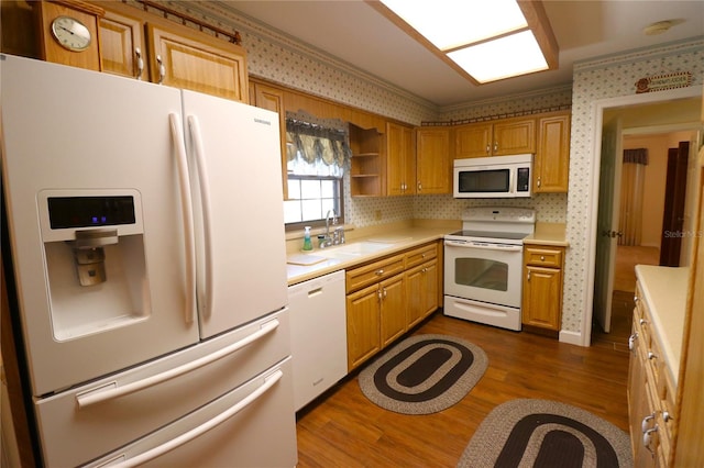 kitchen featuring white appliances, dark wood-type flooring, and sink