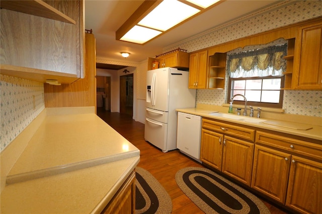 kitchen with white appliances, sink, ornamental molding, dark wood-type flooring, and decorative backsplash