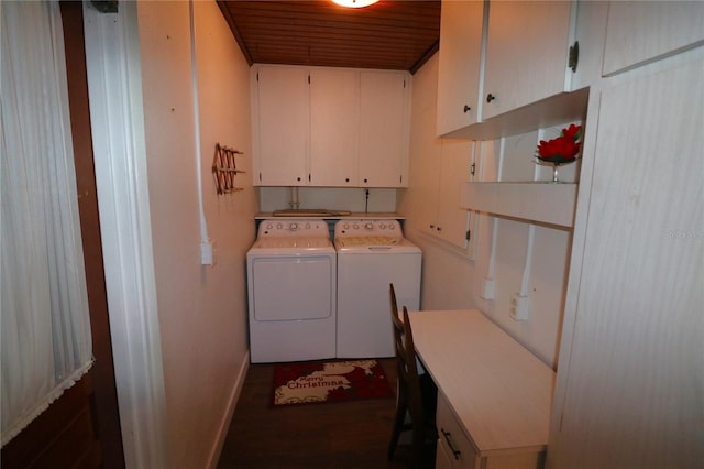 clothes washing area featuring wood ceiling, cabinets, washing machine and clothes dryer, and dark hardwood / wood-style flooring