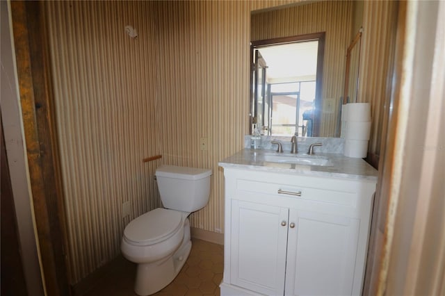 bathroom featuring toilet, vanity, and tile patterned floors