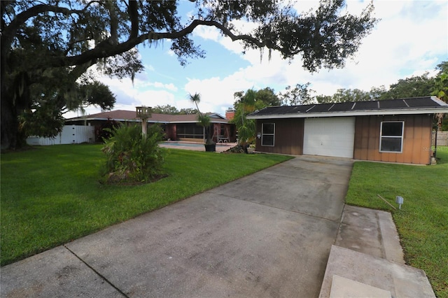 ranch-style house with a front yard and solar panels