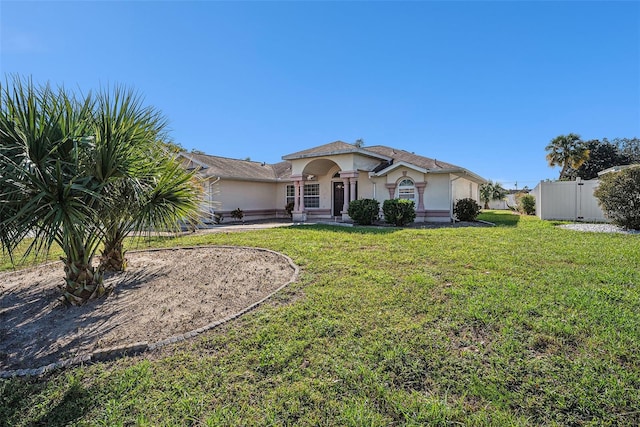 single story home with a front lawn and a patio