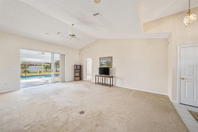 unfurnished living room featuring lofted ceiling, ceiling fan, light carpet, and a textured ceiling