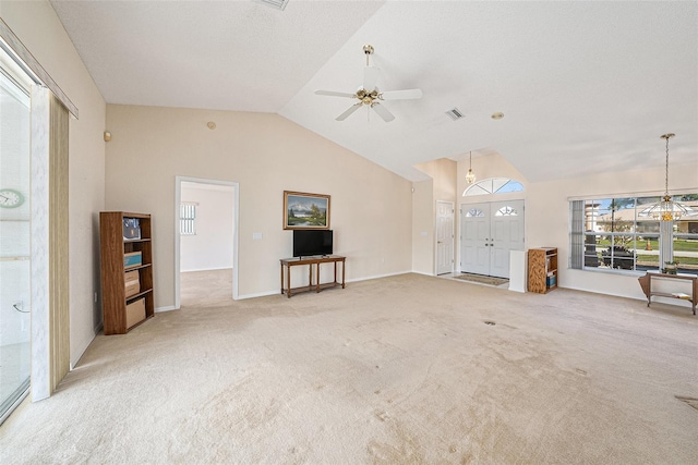 unfurnished living room featuring light colored carpet, vaulted ceiling, and ceiling fan