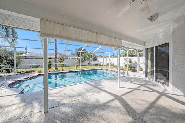 view of pool featuring ceiling fan, a patio area, and a lanai