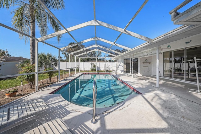 view of swimming pool featuring a lanai and a patio area