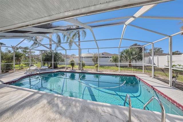 view of swimming pool featuring glass enclosure and a patio