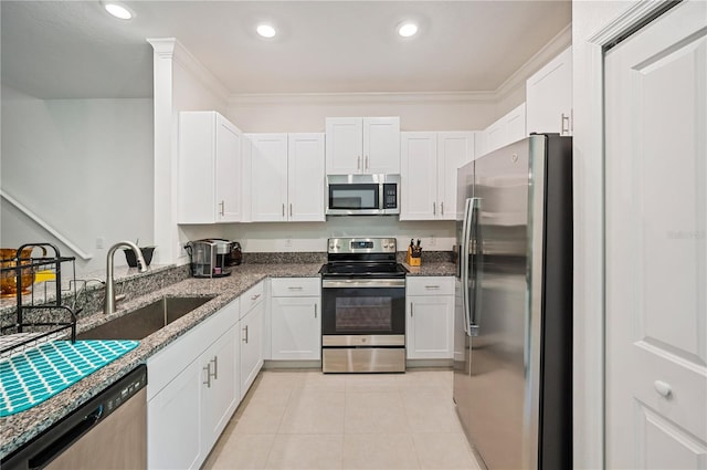 kitchen featuring white cabinets, stainless steel appliances, sink, and dark stone countertops