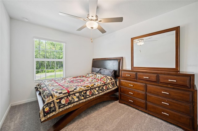 bedroom featuring ceiling fan and light carpet