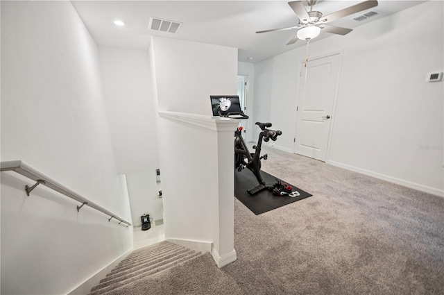 exercise area with ceiling fan and carpet flooring