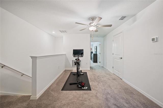 exercise room featuring ceiling fan and light carpet