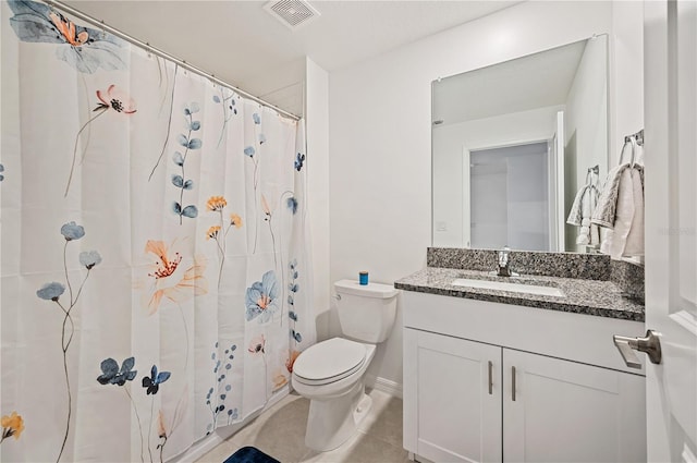 bathroom featuring toilet, curtained shower, vanity, and tile patterned floors