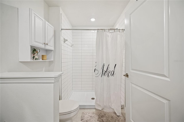 bathroom with a shower with curtain and toilet