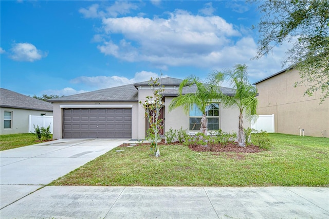 view of front of home featuring a garage and a front yard