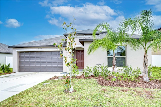 view of front of house featuring a front lawn and a garage