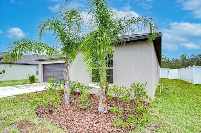 view of property exterior featuring a yard and a garage