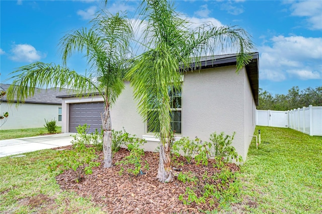 view of side of home with a garage and a lawn