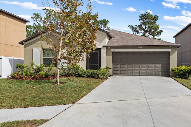 single story home featuring driveway, a front lawn, and stucco siding