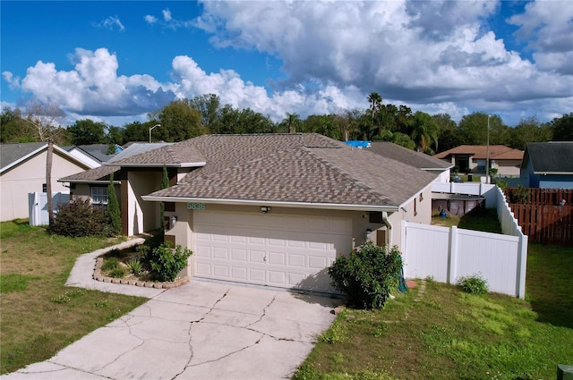 view of front of house featuring a front lawn and a garage