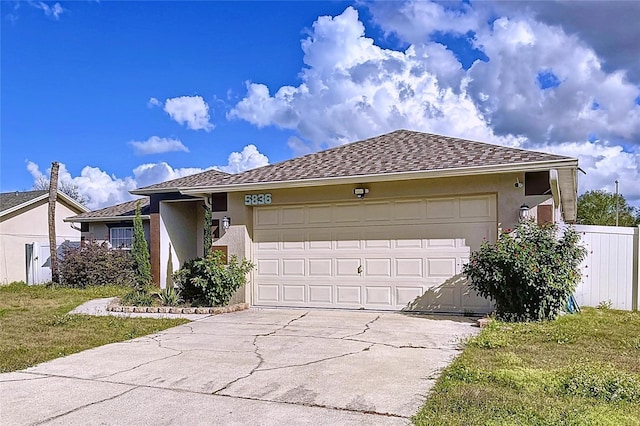 view of front of home featuring a garage and a front lawn