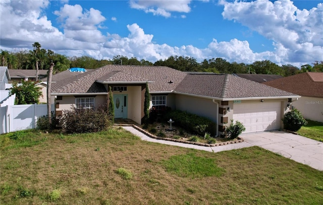 ranch-style home featuring a garage and a front lawn