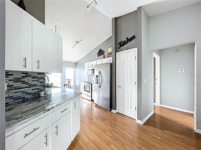 kitchen featuring white cabinets, rail lighting, stainless steel appliances, and a textured ceiling