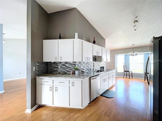 kitchen featuring white cabinetry, pendant lighting, a textured ceiling, appliances with stainless steel finishes, and light wood-type flooring