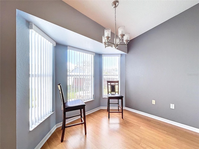 sitting room featuring hardwood / wood-style floors and a chandelier