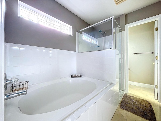 bathroom with tile patterned flooring, plus walk in shower, and a healthy amount of sunlight