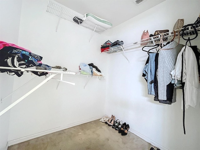 walk in closet featuring carpet flooring