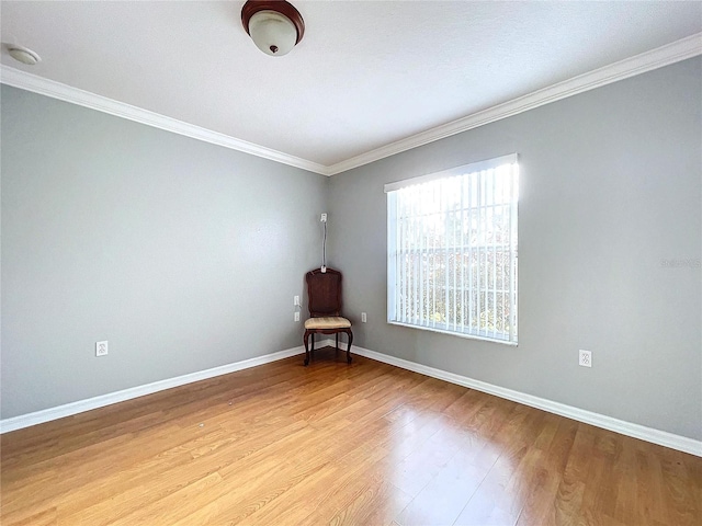 empty room featuring light hardwood / wood-style floors and crown molding