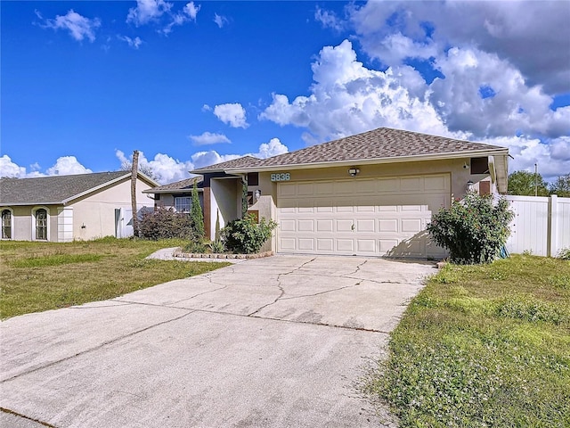 view of front of home with a front yard and a garage