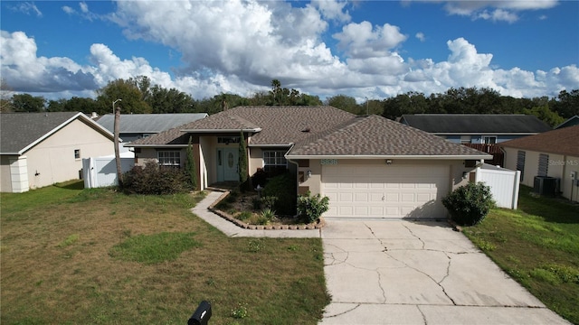 ranch-style house with a front yard, central AC, and a garage