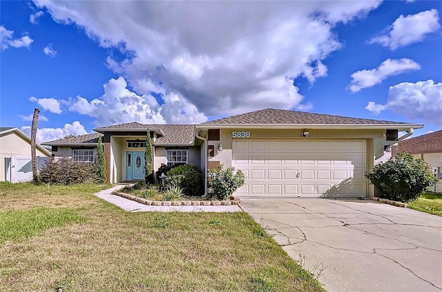 view of front of house with a garage and a front lawn