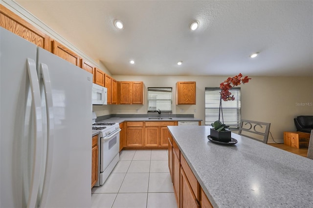 kitchen featuring sink, white appliances, and light tile patterned floors