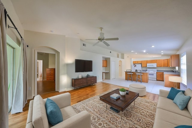 living room with ceiling fan, light hardwood / wood-style flooring, and sink