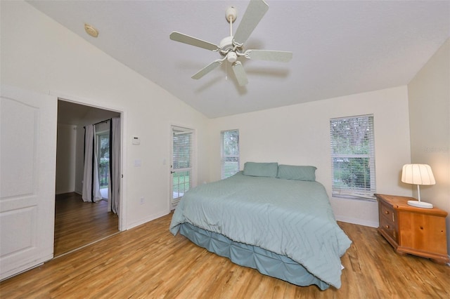 bedroom with lofted ceiling, ceiling fan, and light wood-type flooring