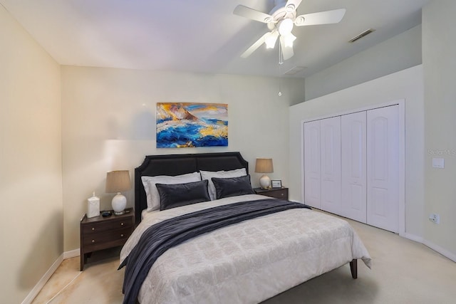 bedroom featuring a closet, light carpet, and ceiling fan