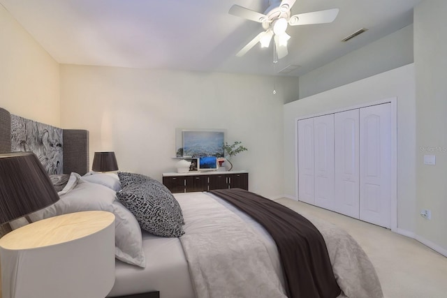 bedroom with ceiling fan, a closet, and light carpet